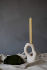 Handmade beeswax candle, interior design with authentic decor