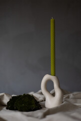 Handmade beeswax candle, interior design with authentic decor