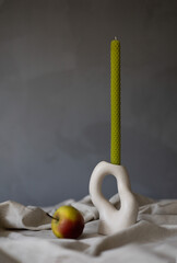 Handmade beeswax candle, interior design with authentic decor