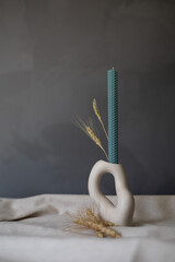 Handmade beeswax candle, interior design with authentic decor