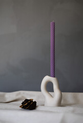 Handmade beeswax candle, interior design with authentic decor