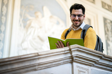 Male student studying indoor in a university open space