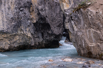 Rapid Crystal Clear Streams of Mountain Glacier Bow River Flow Through The Crack In The Rock, Canadian Rockies, Banff, Alberta, Canada