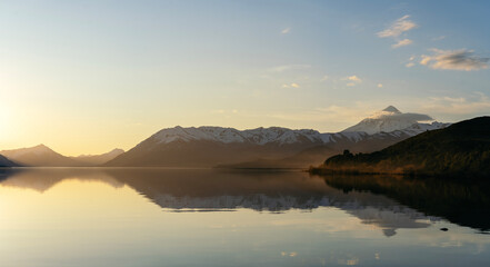 Obraz premium Majestic golden hour with snow capped mountains and calm water lake. Lanin National Park, Patagonia Argentina