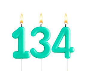 Green birthday candle on white background - Candle number 134