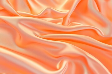 Fototapeta premium A close-up of soft, flowing orange satin fabric with gentle folds and creases.