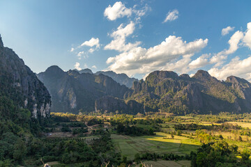 Obraz premium Countryside with farmland and karst mountains in the Vang Vieng. Vang Vieng, Vientiane Province, Laos