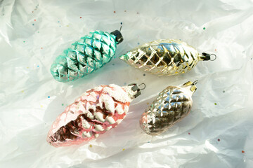 Vintage colored glass colored Soviet Christmas tree toy cones. Retro style Christmas ornament on white paper with blurred focus. Vintage Christmas tree toys, collecting