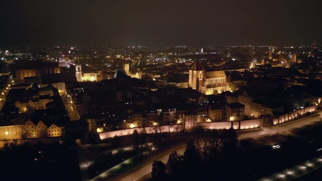 Night view from a drone of illuminated Torun, Poland