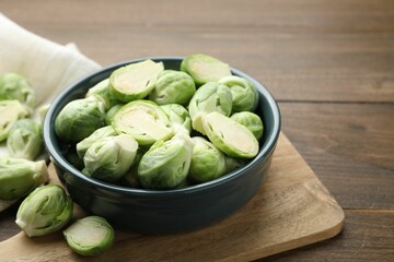 Fresh green Brussels sprouts on wooden table, closeup. Space for text