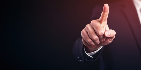 A businessman gesturing with a finger raised, indicating authority and focus.