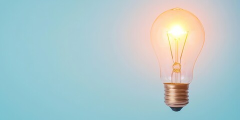 A glowing light bulb against a soft blue background, symbolizing innovation and ideas.