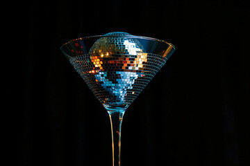 Cocktail party with disco ball on black color background. Disco party, retro fashion. Modern stylish backdrop template for holiday card, banner, flyer, menu with space for text