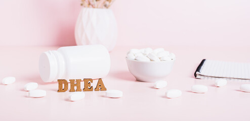 Hormonal supplement DHEA in tablets and a notebook on the table web banner