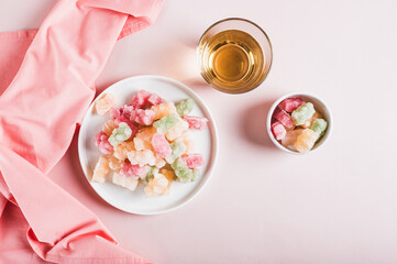 Dry frozen gummy bears candies on plate on table top view