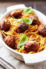 Spaghetti Pasta with Meatballs and fresh Basil on bright background. Close up.