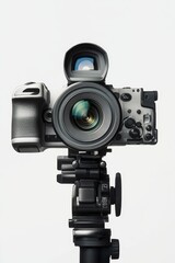 A camera on a tripod, isolated on white.