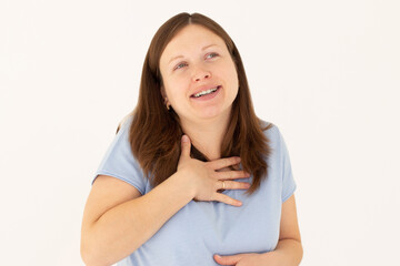 Portrait of extremely happy girl in blue t-shirt holding her stomach and chest and laughing out loud, chuckling giggling at amusing anecdote, sincere emotion. isolated on white background