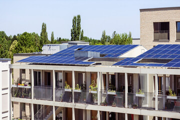 Modern Apartment Building with Solar Panels Roof and Urban Terrace and Stairway. New Smart...