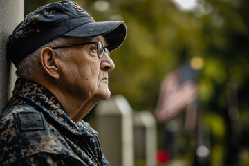 Elderly veteran in uniform is paying his respects at a military memorial, lost in solemn contemplation