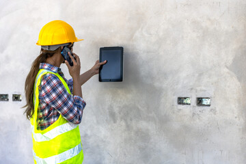 Inspector woman using phone during house inspecting 