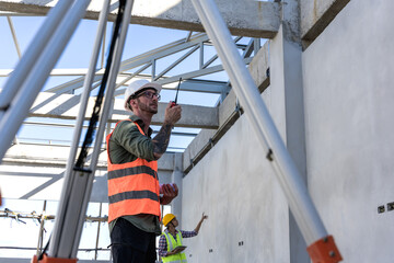 Builder using hand radio working in construction site
