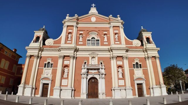Carpi's cathedral Santa Maria Assunta, showcasing its baroque facade with statues and intricate details under a clear blue sky in emilia romagna, Italy, a symbol of italian architecture and religious