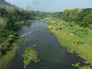 Scenic Aerial View of Lush River Valley Landscape in Spring