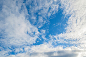 Fototapeta premium Blue sky sunset landscape with picturesque clouds lit by evening sunlight - colorful evening sky view