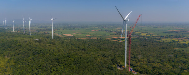 Wind turbine being repaired. Engineers are checking turbine wing on top of a  Hight Crane at  Wind...