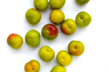 Fresh green plum on white background
