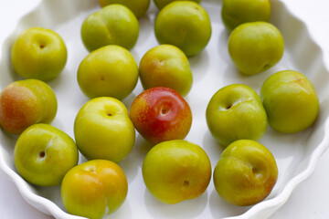 Fresh green plum on white background