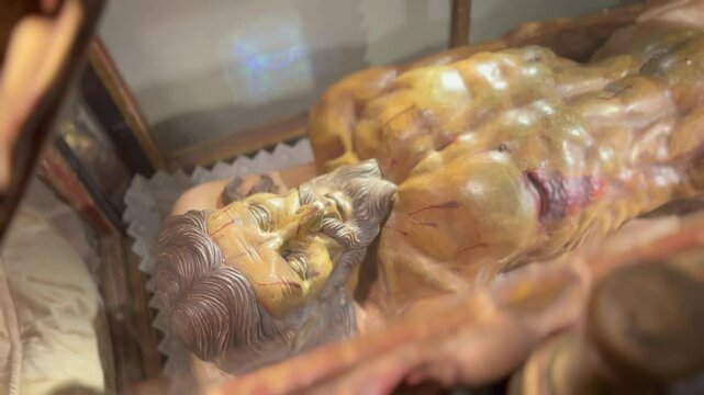 Ornate reliquary containing mummified religious figure.