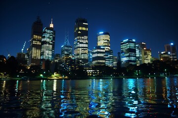 Obraz premium Nighttime City Skyline with Illuminated Buildings