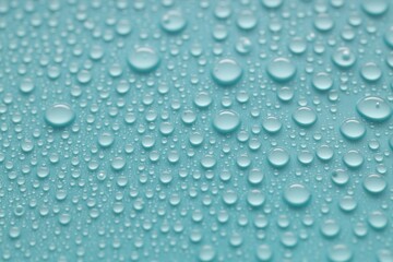 Water drops on turquoise background, above view