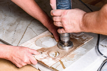 Drilling hole in ceramic tile with diamond crown using template and water.