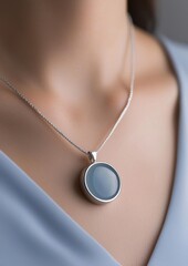 A woman wearing a necklace with a blue stone pendant