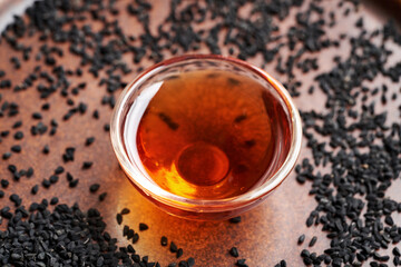 Black cumin or Nigella sativa seed oil in a glass bowl