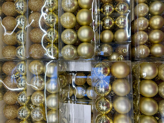 Lots of gold Christmas tree decorations in the store