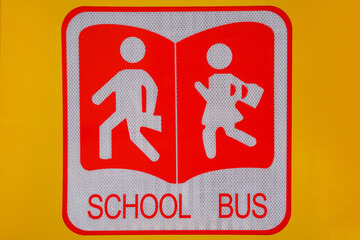 School bus sign on a yellow background.