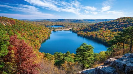 Fototapeta premium Stunning autumn view of Oak Mountain State Park showcasing vibrant foliage and serene waters on a clear day
