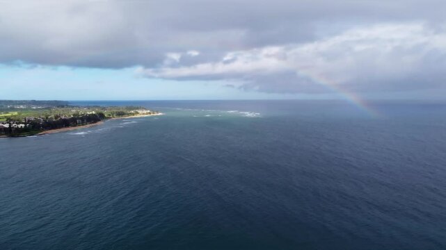 Rainbow in pacifica ocean at Lydgate Beach park near Wailua bay in Kauai. Holiday in paradise. Rainbow in the sky over the ocean of Hawaii