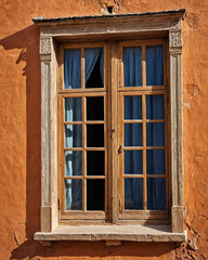 Fototapeta premium Antique Moroccan wooden door with intricate Islamic geometric patterns, aged turquoise paint, and ornate metal accents, capturing traditional craftsmanship and historic architecture in a rustic old