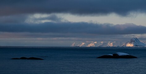 Snow-capped mountains under a dramatic sky