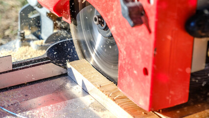 A close-up shot of a circular saw cutting timber in a garden