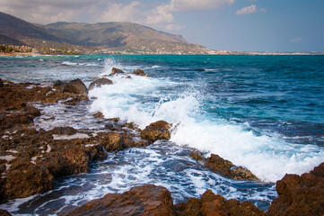 Scenic Rocky Coastline with Waves under Blue Sky in Crete, Greece