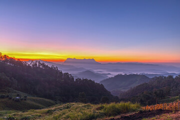 Fototapeta premium Mountain peaks in morning fog - foggy morning Landscape of sunrise on Mountain at Doi Luang Chiang Dao, Chiang Mai ,Thailand