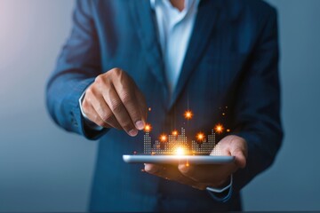 businessman holding a tablet with glowing financial data and digital bar charts emerging from the screen, symbolizing modern analytics and technology.
