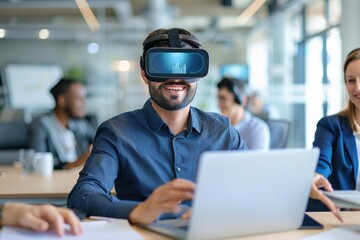 A smiling man in a modern office wears a virtual reality headset while working on a laptop, illustrating VR technology use in business collaboration.