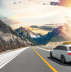 The car is driving along the highway surrounded by picturesque nature.